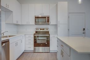 West Point apartment for rent - A modern kitchen with white cabinets and stainless steel appliances.