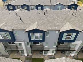 Clearfield townhouse for rent - A row of houses with grey roofs and dark blue walls.