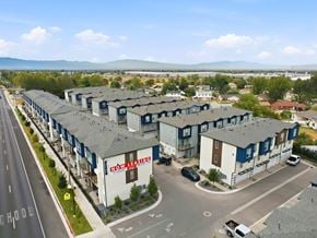 Clearfield townhouse for rent - A view of a road with a building that has a sign that says "ROW LEASING".