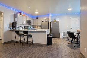 Saint George apartment for rent - A kitchen with a bar area and a refrigerator.