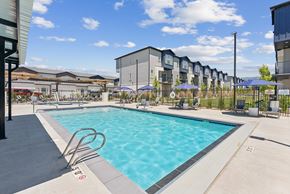 Clearfield townhouse for rent - A swimming pool surrounded by a fence and apartment buildings.