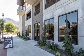Provo apartment for rent - a building with a sidewalk and plants in front of it