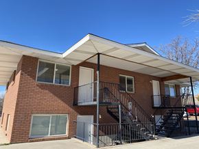 Saint George apartment for rent - A red brick house with a black metal staircase.