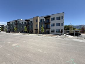 Layton apartment for rent - A large building with a parking lot in front of it.