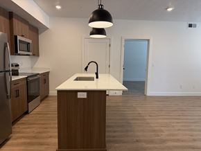 Layton apartment for rent - A kitchen with a white countertop and wooden cabinets.