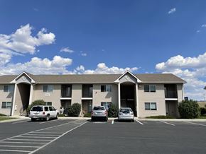 Laramie apartment for rent - A white car is parked in front of a building.