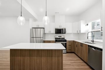 Clearfield townhouse for rent - A modern kitchen with a wooden island and stainless steel appliances.