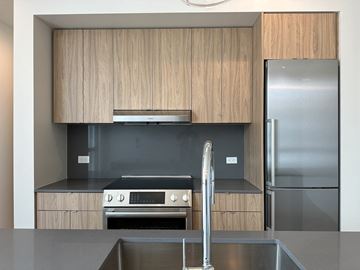Salt Lake City apartment for rent - A modern kitchen with wooden cabinets and stainless steel appliances.