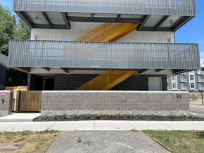 Salt Lake City apartment for rent - the front of a building with a staircase on top of a brick wall
