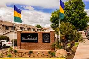 St.George apartment for rent - the pointe sign in front of a brick building with flags on the