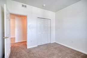 Rexburg apartment for rent - a bedroom with white walls and carpet