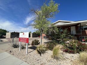 Saint George apartment for rent - A building with a red sign in front of it.