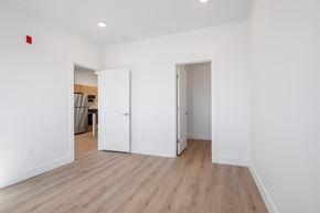 Hurricane apartment for rent - a renovated living room with white walls and wood flooring