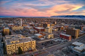 Casper apartment for rent - A cityscape with buildings and roads under a pink and blue sky.