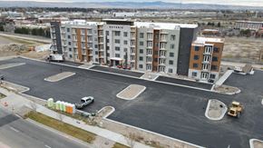 Idaho Falls apartment for rent - A large building with the word "RESERVOIR" on the side is surrounded by a parking lot.
