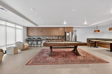 Idaho Falls apartment for rent - A living room with a rug on the floor and a dining table in the middle.