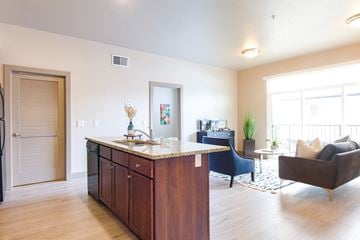 Salt Lake City apartment for rent - a living room with a kitchen and a couch and a table