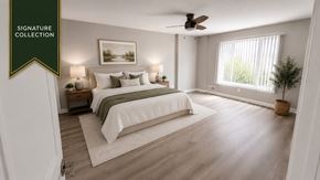 Southfield townhouse for rent - A bedroom with a large bed and a ceiling fan.