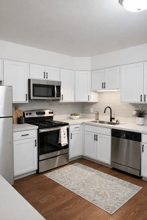 Southfield townhouse for rent - A kitchen with white cabinets and stainless steel appliances.