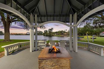 Lakeside gazebo with fire pit and seating area