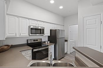 Fully-equipped, upgraded kitchens with wood-look flooring, spacious pantries and updated cabinetry