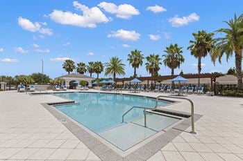 Resort-style swimming pool with hot tub