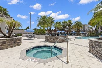 Resort-style swimming pool with hot tub