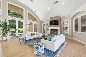 Folsom apartment for rent - A living room with a white couch and a blue and white ottoman.