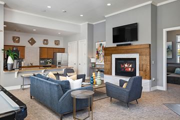 Overland Park apartment for rent - a living room with a fireplace and a table and chairs