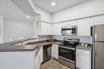Stainless steel appliances including full-sized frost-free refrigerators with ice makers and multi-cycle dishwashers