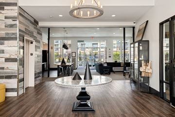 Kansas City apartment for rent - a living room with a round table and a view of the city