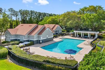 Resort-style swimming pool with pergola and grilling area