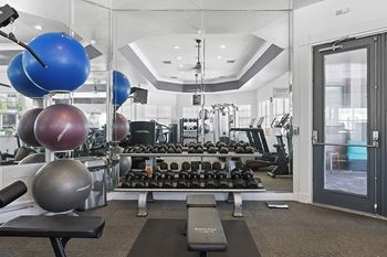 Fitness center featuring cardio, strength training and flat screen tvs