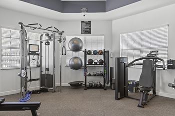 Fitness center featuring cardio, strength training and flat screen tvs