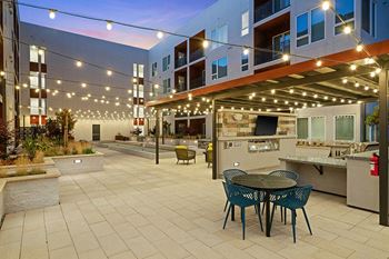 Bocce courtyard with fire tables, bbq pavilion, outdoor fireplace and outdoor tvs