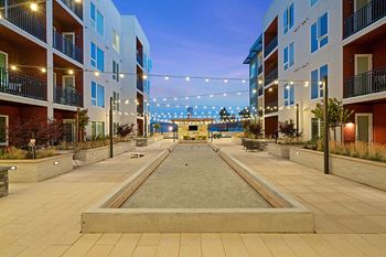 Bocce courtyard with fire tables, bbq pavilion, outdoor fireplace and outdoor tvs