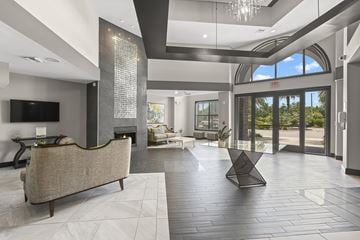 Wesley Chapel apartment for rent - A modern living room with a large couch and a fireplace.