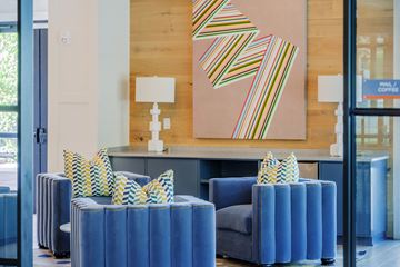 Charleston apartment for rent - a living room with blue furniture and a painting on the wall