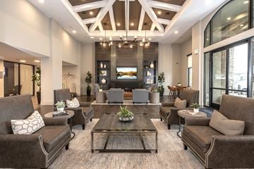 Folsom apartment for rent - A large, modern living room with brown couches and a coffee table.