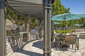 Outdoor patio with bbq grill and dining tables