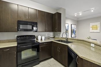 Upgraded black appliance package with glass top range and built-in microwave