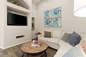 Peoria apartment for rent - A living room with a white couch and a wooden coffee table.