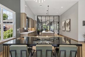 Lone Tree apartment for rent - A modern kitchen with a glass table and chairs.