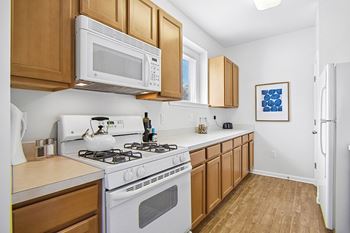 Spacious kitchens with a breakfast bar, a gas range and a gourmet appliance package, including a dishwasher, a disposal and a built-in microwave
