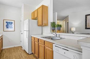 Spacious kitchens with a breakfast bar, a gas range and a gourmet appliance package, including a dishwasher, a disposal and a built-in microwave