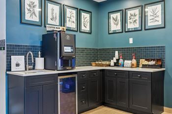 Resident clubhouse with fireplace and kitchen