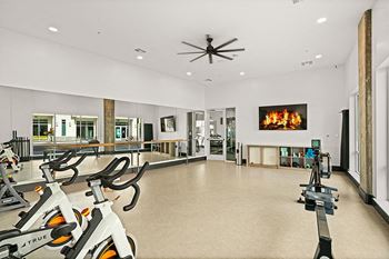 Yoga studio with ballet barre and spin bikes