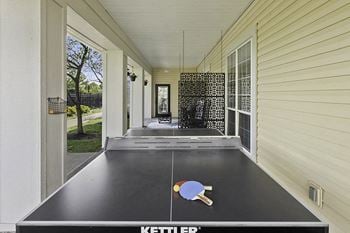 Patio with ping pong table and lounge area
