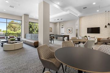 Redlands apartment for rent - A modern living room with a large table and chairs.