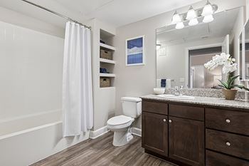 Wood-style flooring in kitchen, entry and bath
